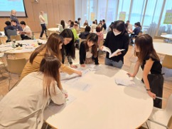 PD participants around a round table checking papers